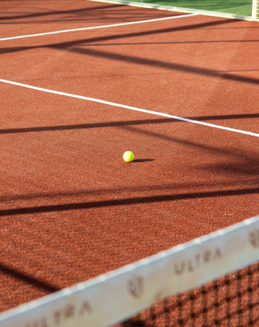 A padel ball resting on the Ultra Padel Miami court